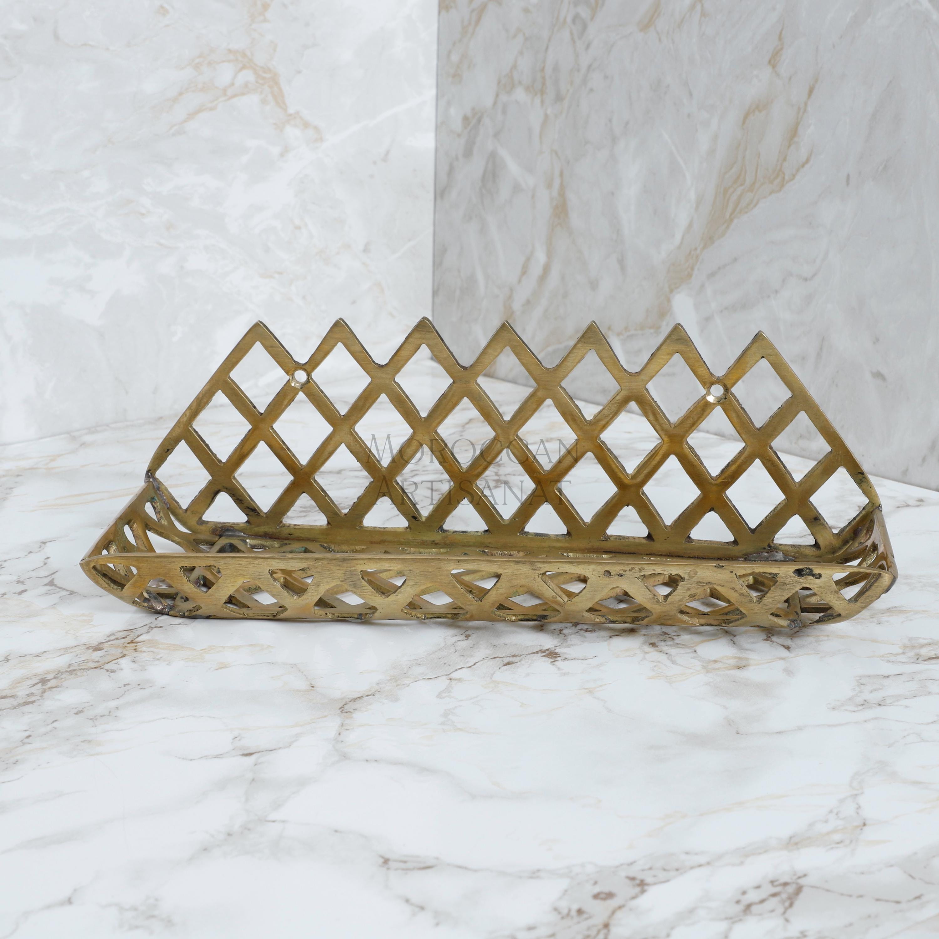 a gold decorative object on a marble surface