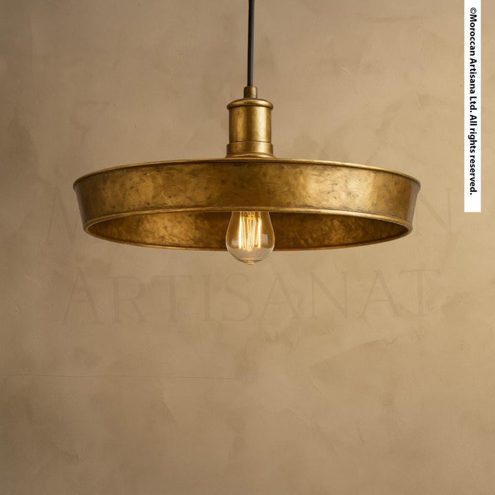 A gold-colored pendant light with a single bulb hanging from the ceiling.