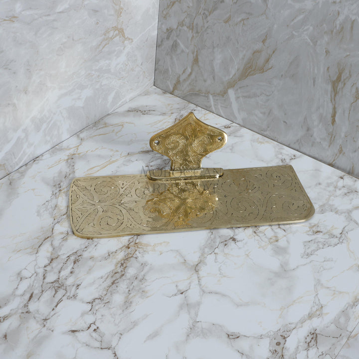 a marble counter top with a gold handle on it