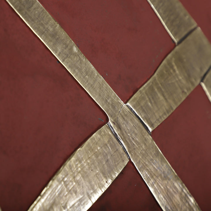 a close-up view of a metallic surface with a pattern of intersecting lines, creating a sense of depth and texture.