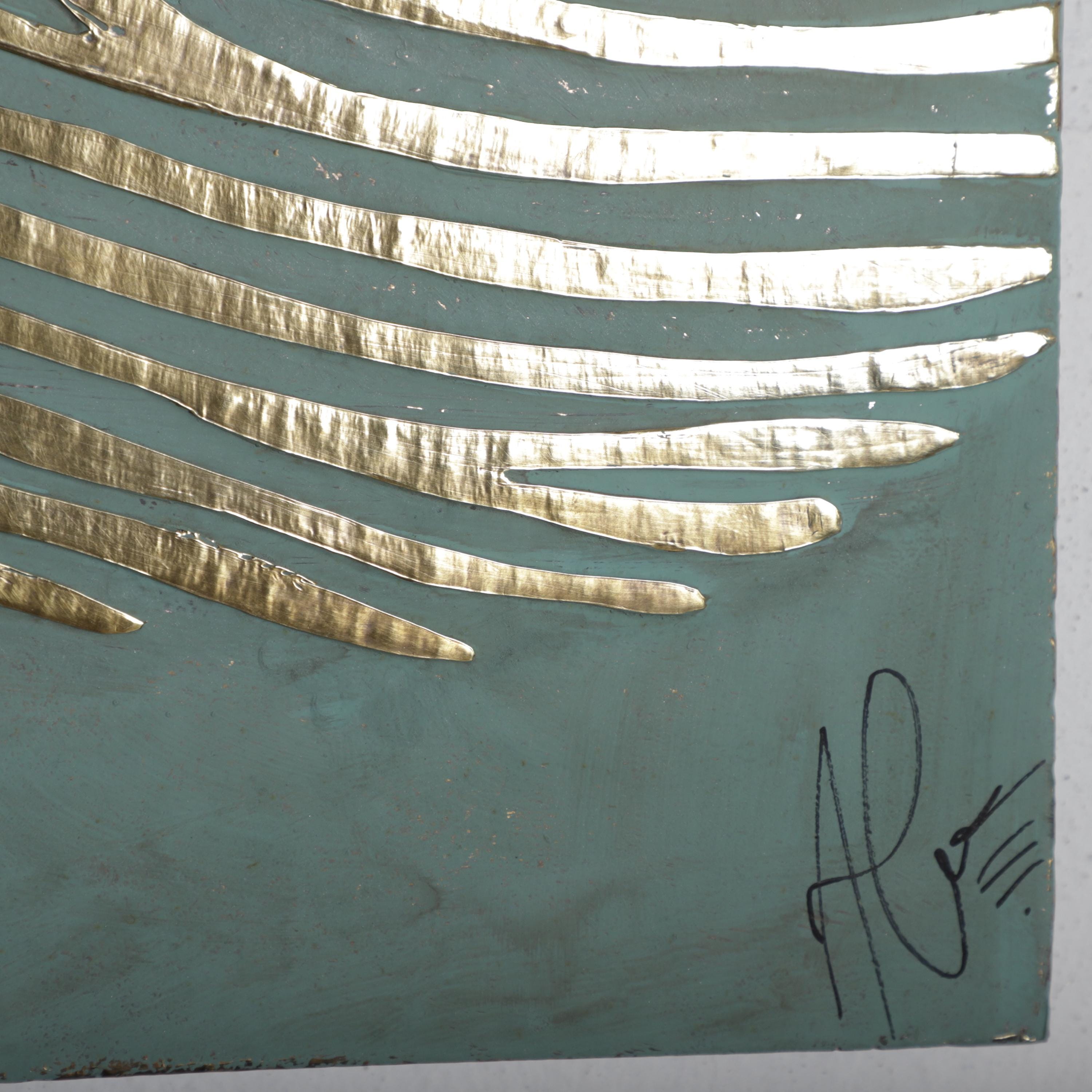 a close-up view of a piece of art with a textured background and a metallic, golden-colored line pattern.