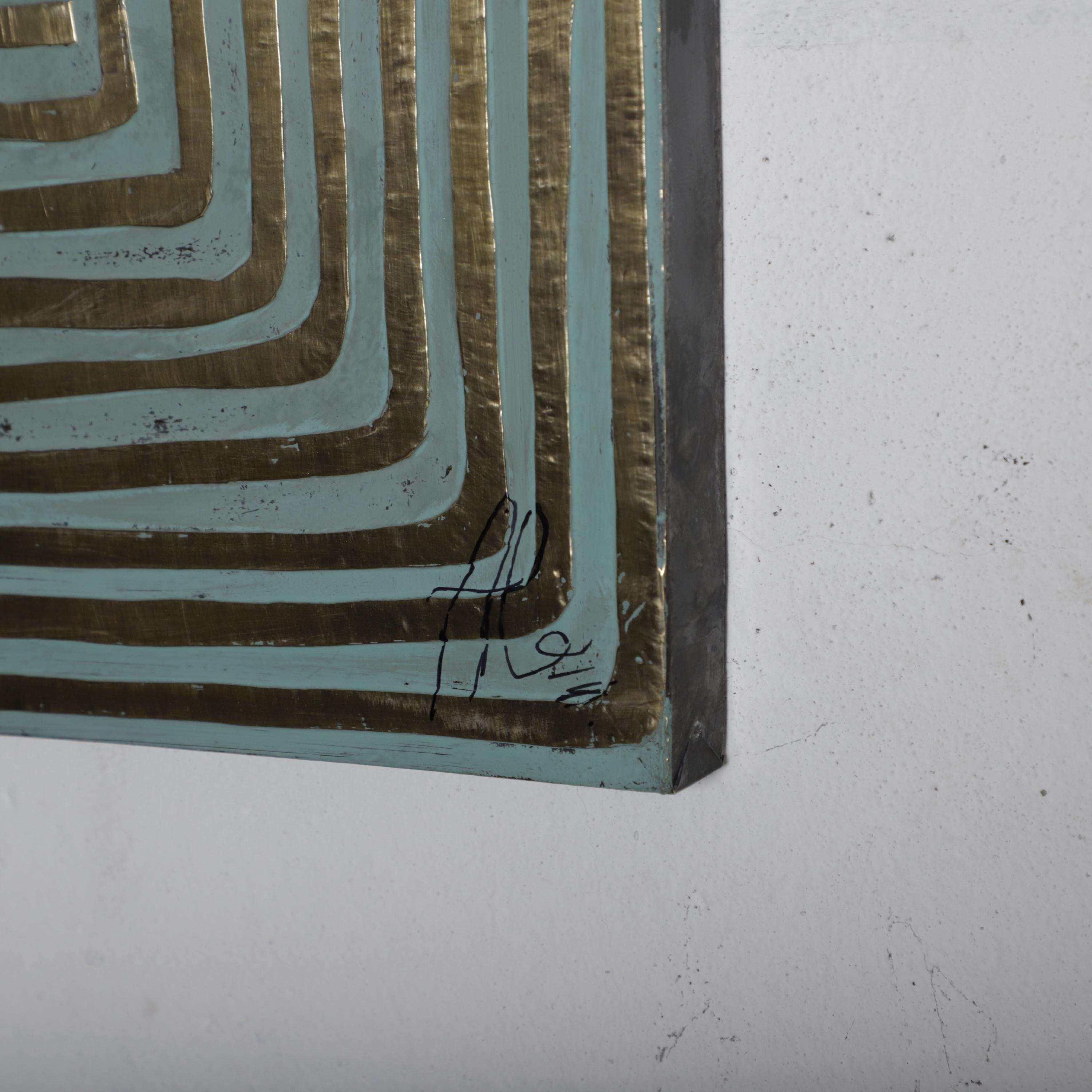 a close-up view of a piece of art with a geometric pattern in shades of blue and gold.