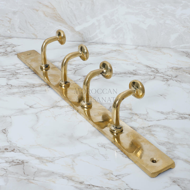 a pair of brass hooks on a marble counter