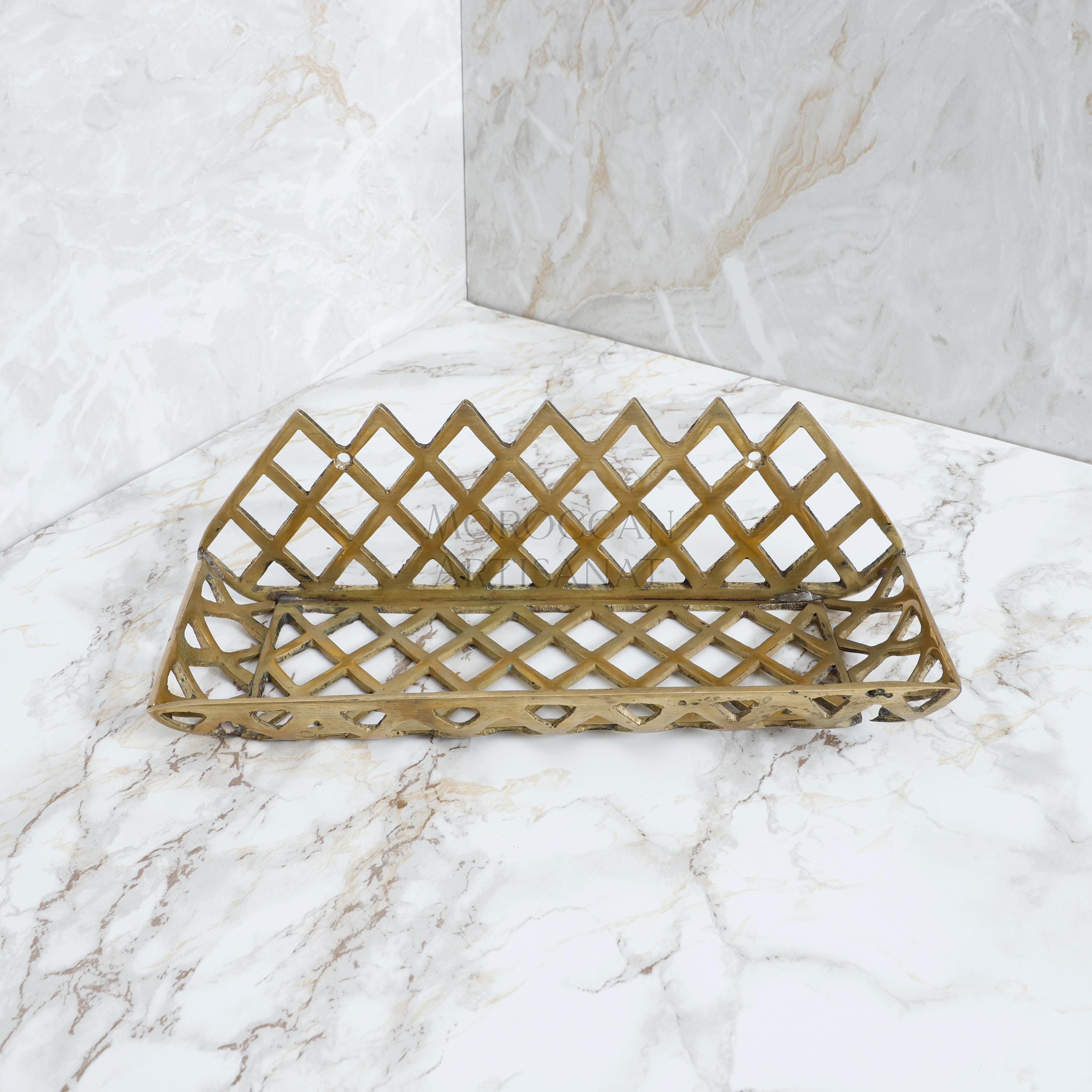 a golden basket sitting on top of a marble counter
