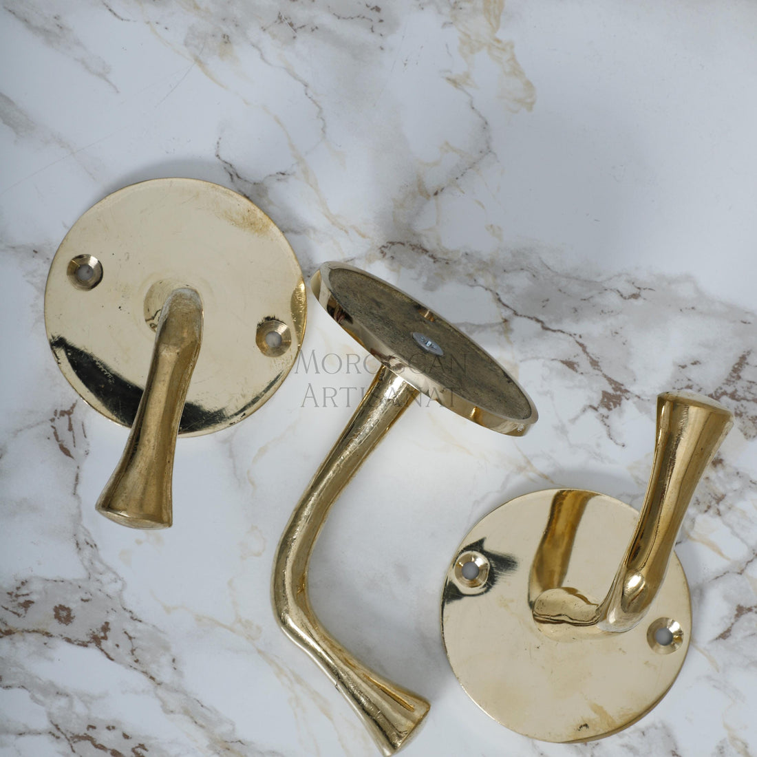 a pair of brass door handles on a marble surface