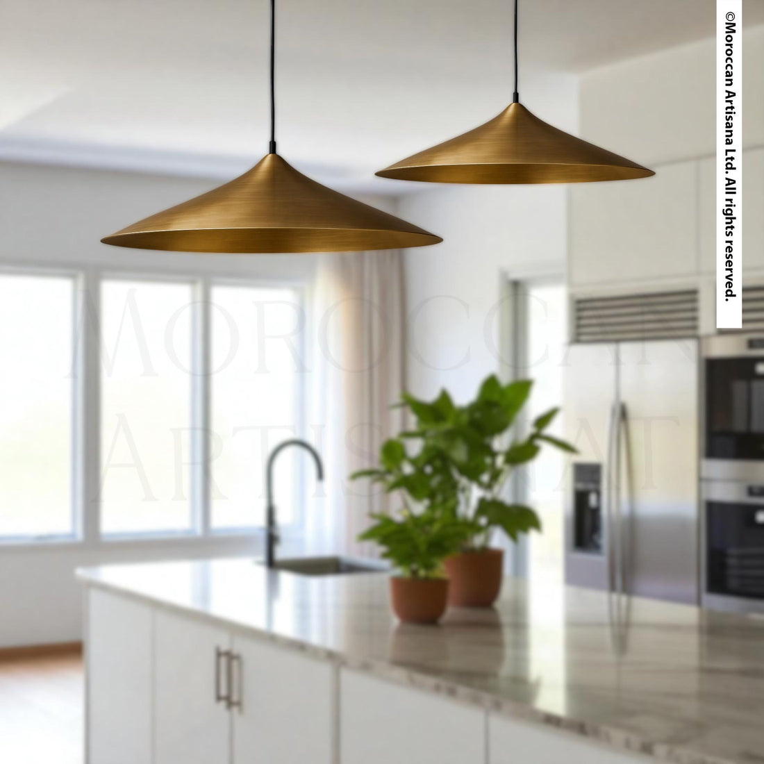 a modern kitchen with two pendant lights hanging above a marble countertop. The kitchen has white cabinets and stainless steel appliances, creating a sleek and contemporary look.