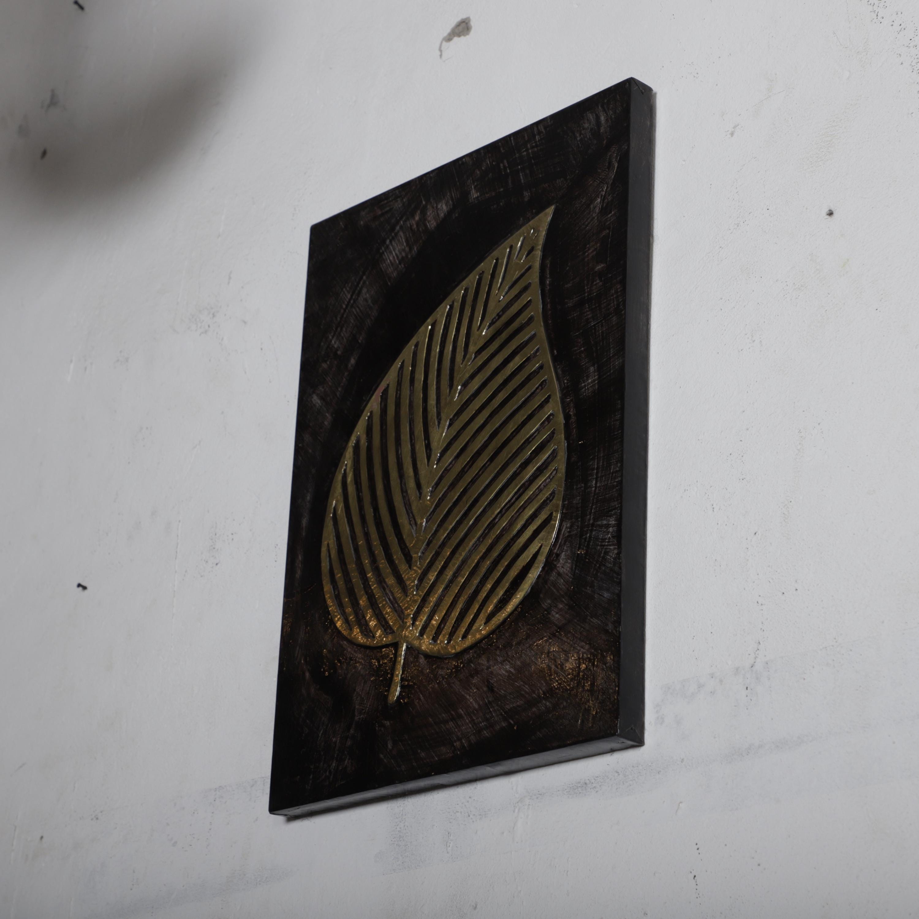 a large, gold leaf-shaped design on a black background.