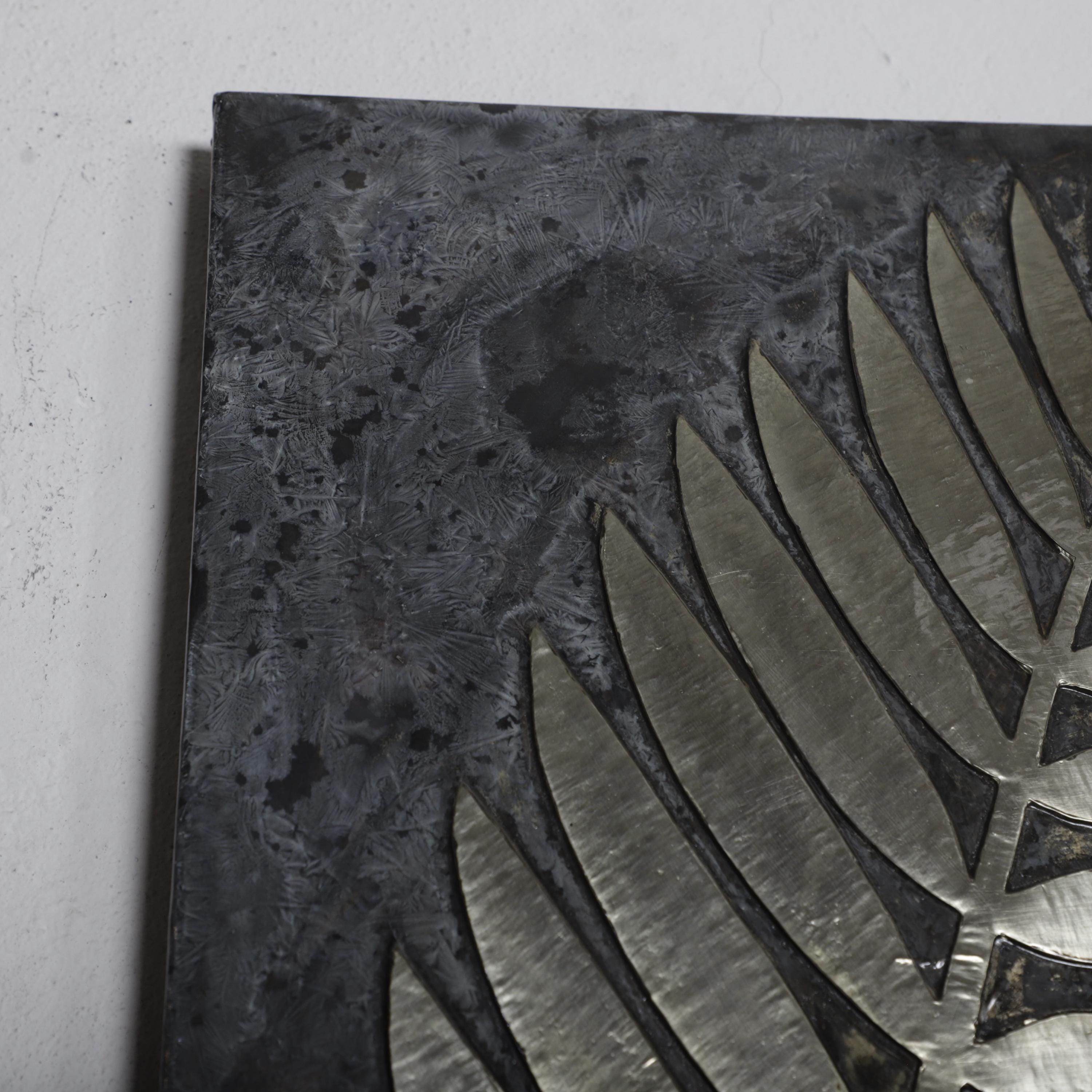 a close-up view of a metal surface with a repeating pattern of metallic blades or blades, creating a textured and visually interesting surface.