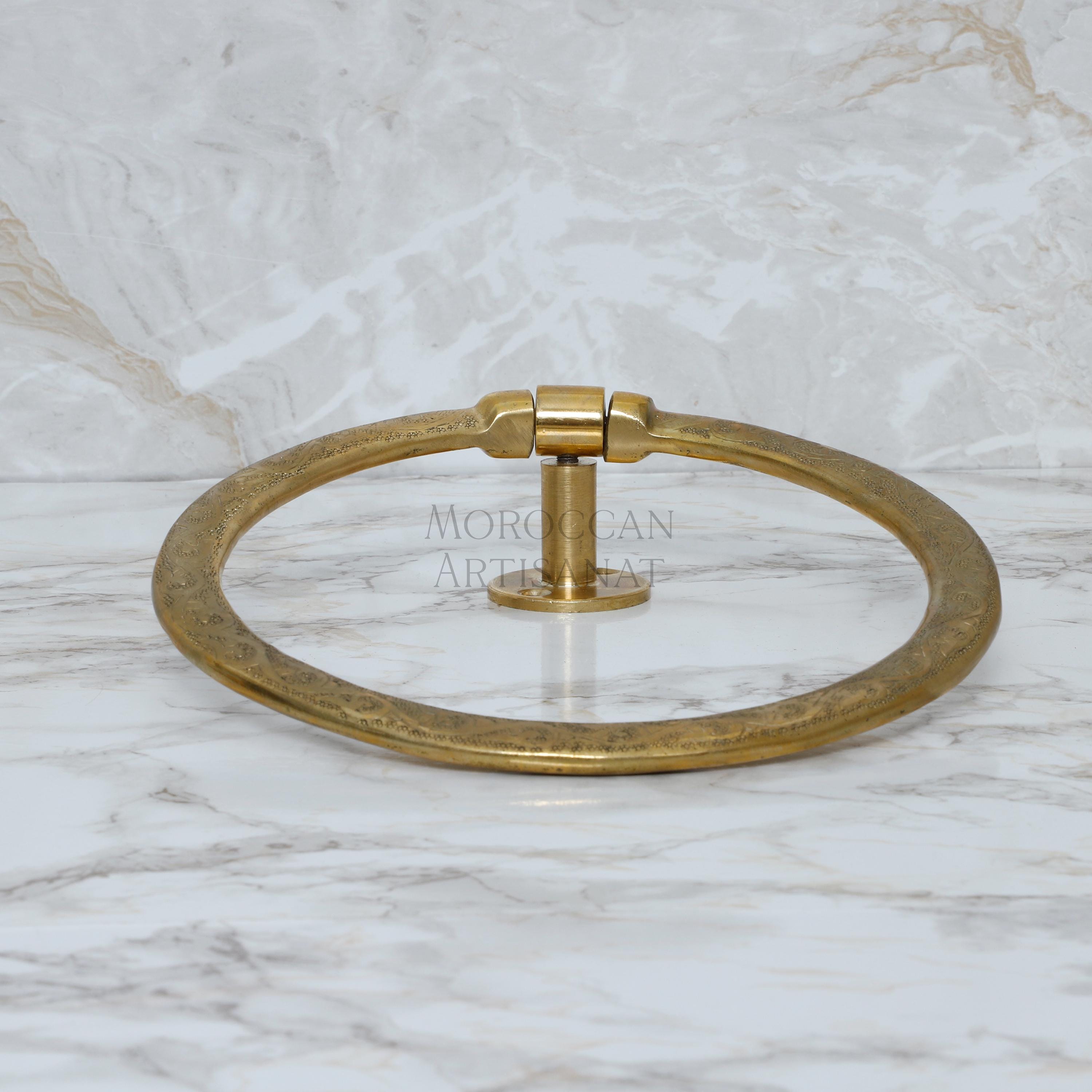 a brass towel ring on a marble counter