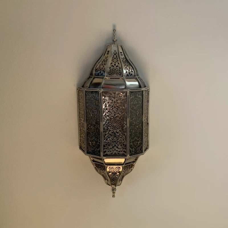 Handmade Moroccan wall sconce with intricate patterns for warm and elegant home lighting decor