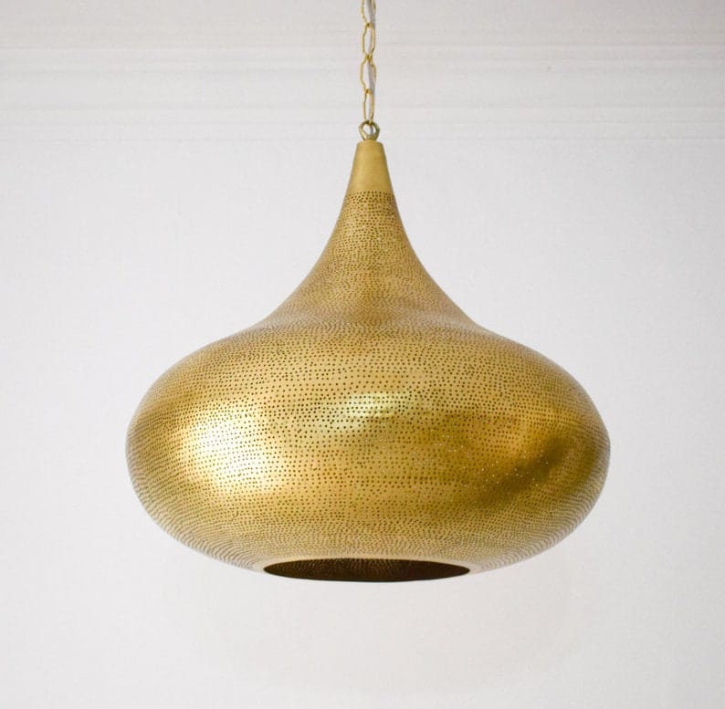 Elegant Moroccan brass pendant light with intricate patterns and warm glow for stylish home decor