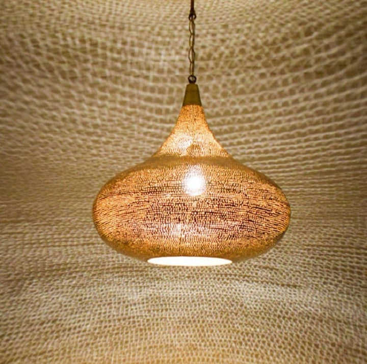 Elegant Moroccan brass pendant light with intricate patterns and warm glow for stylish home decor