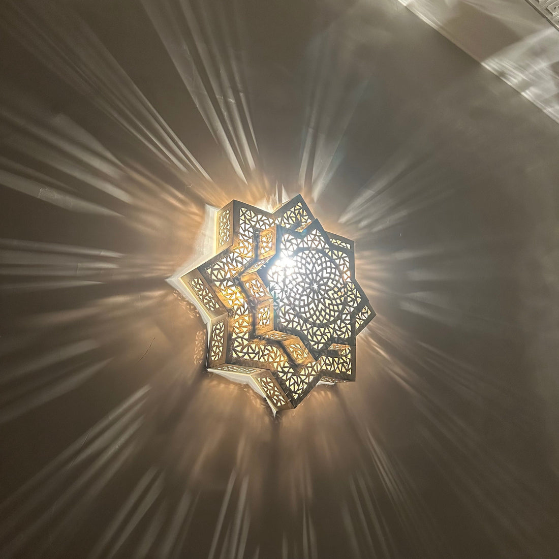 Handcrafted Moroccan brass sconce lighting with intricate patterns for warm and elegant decor