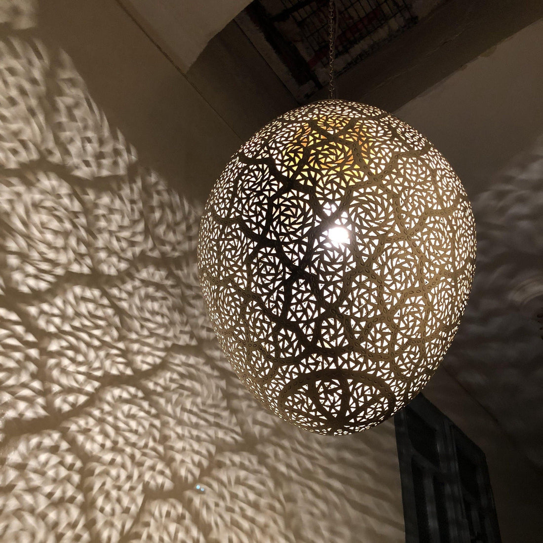 Moroccan pendant lamp brass fixture with intricate patterns for warm and elegant home decor