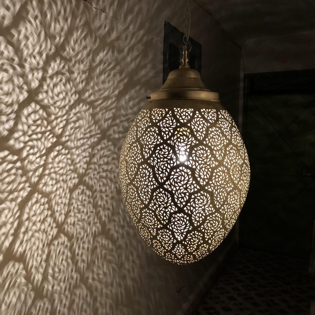 Moroccan pendant lamp brass fixture with intricate patterns for warm and elegant home decor