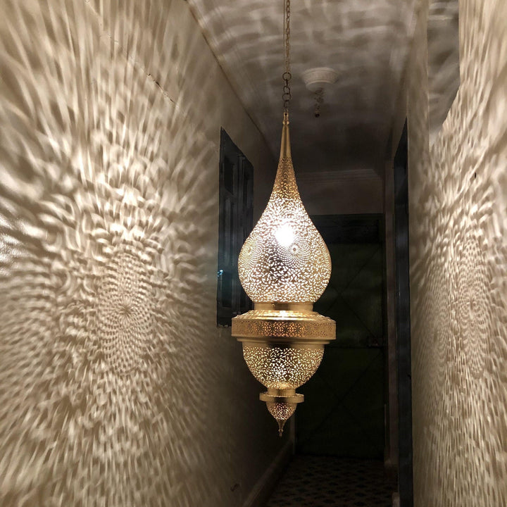 Moroccan pendant light in brass with intricate patterns for a warm and elegant home decor