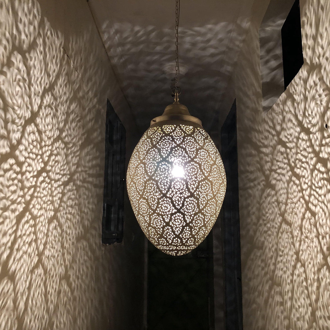 Moroccan pendant lamp brass fixture with intricate patterns for warm and elegant home decor