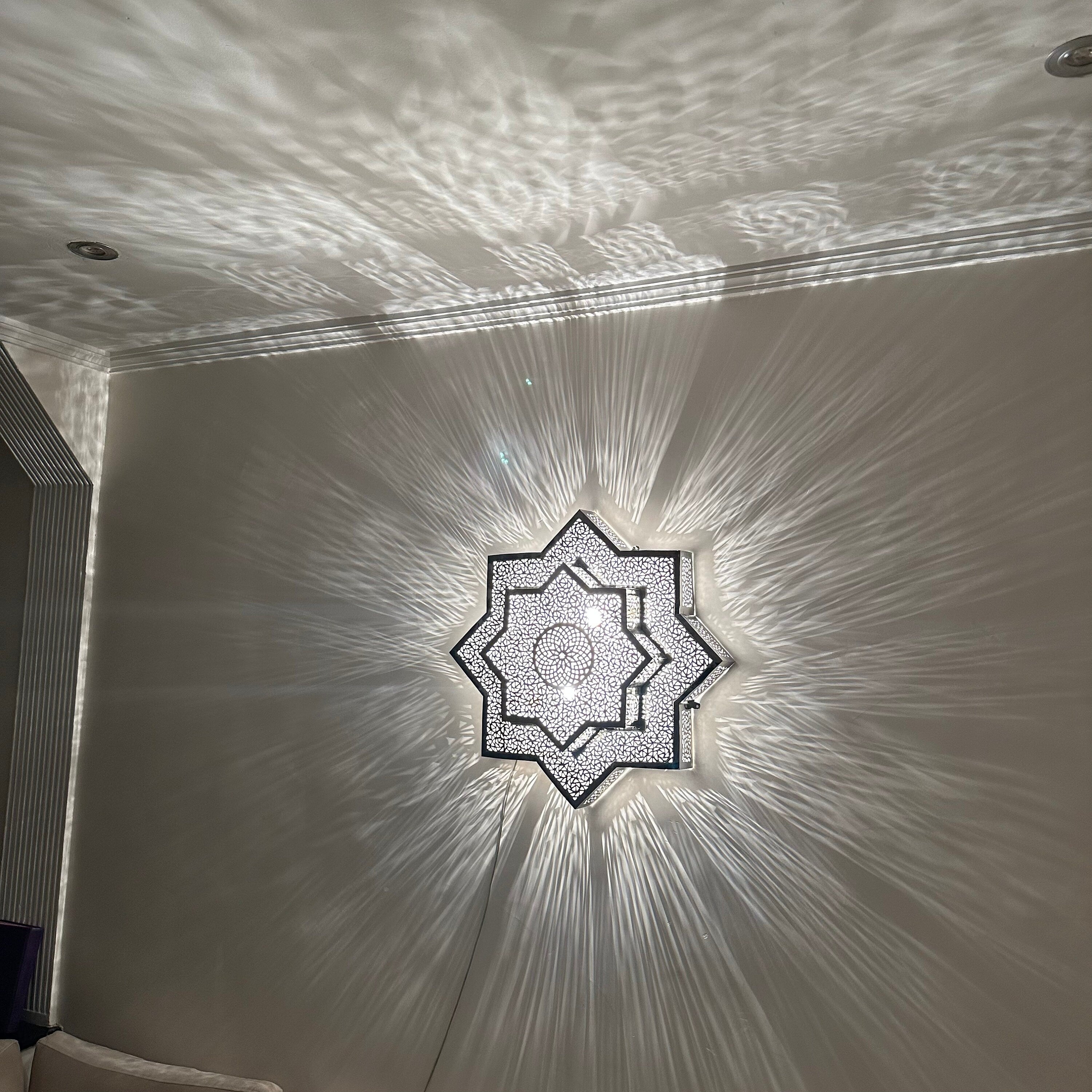 Handcrafted Moroccan brass sconce lighting with intricate patterns for warm and elegant decor