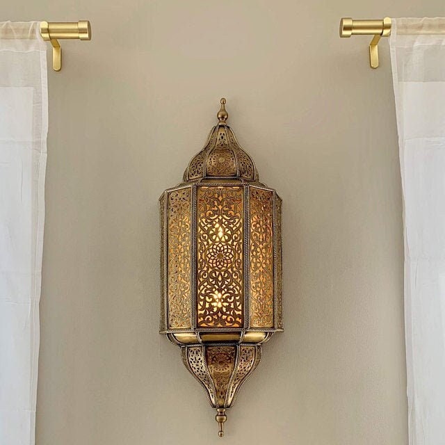 Handmade Moroccan wall sconce with intricate patterns for warm and elegant home lighting decor