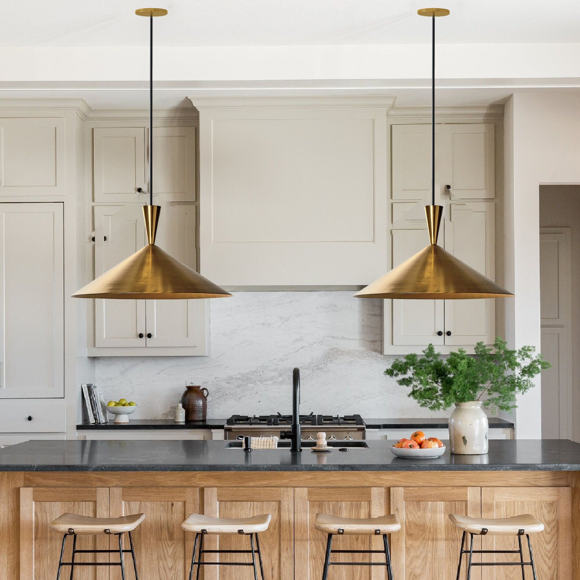 Elegant brass pendant light over a kitchen island with adjustable height