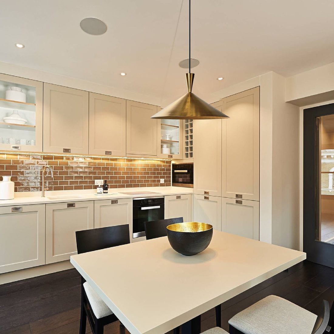 Elegant brass pendant light over a kitchen island with adjustable height