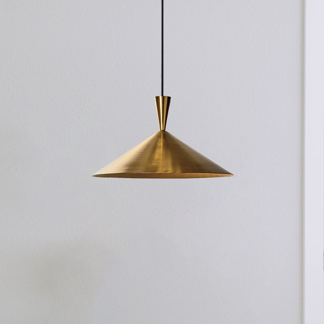 Elegant brass pendant light over a kitchen island with adjustable height