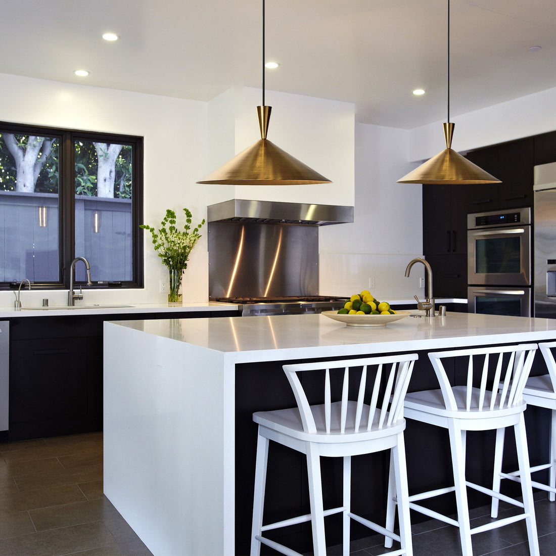 Elegant brass pendant light over a kitchen island with adjustable height