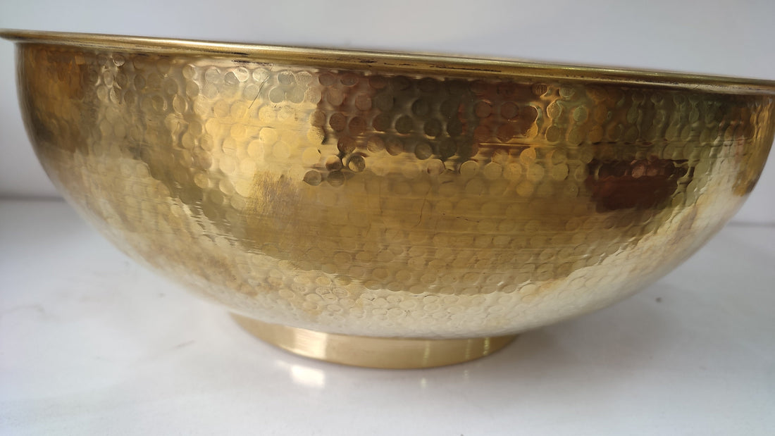 Round brass bathroom sink with a warm finish for an elegant bathroom design