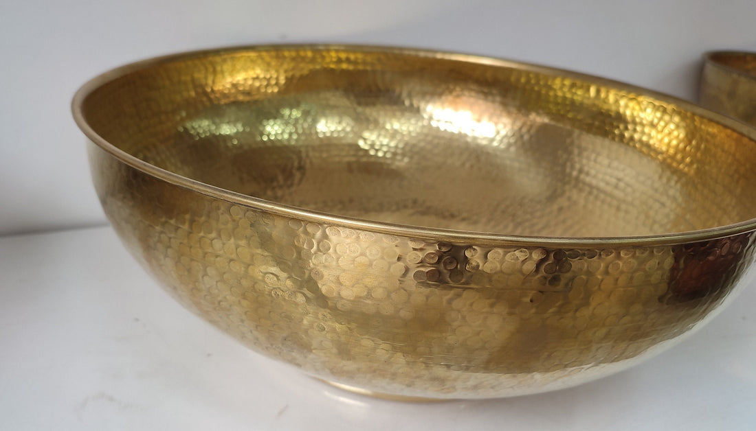 Round brass bathroom sink with a warm finish for an elegant bathroom design