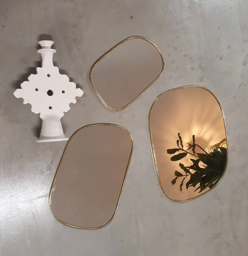 Set of irregularly shaped brass mirrors for modern and artistic home decor