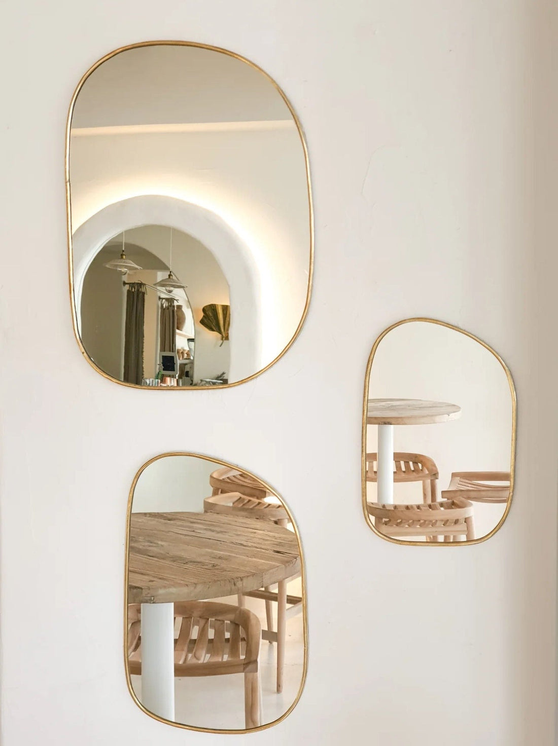 Set of irregularly shaped brass mirrors for modern and artistic home decor