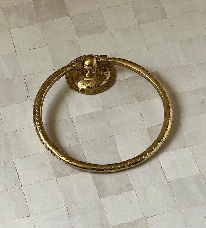 Unlacquered brass towel ring with a minimalist design for elegant bathroom decor