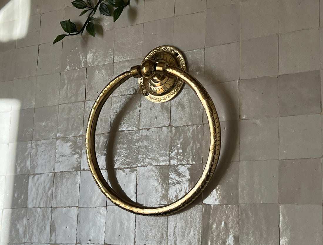 Unlacquered brass towel ring with a minimalist design for elegant bathroom decor