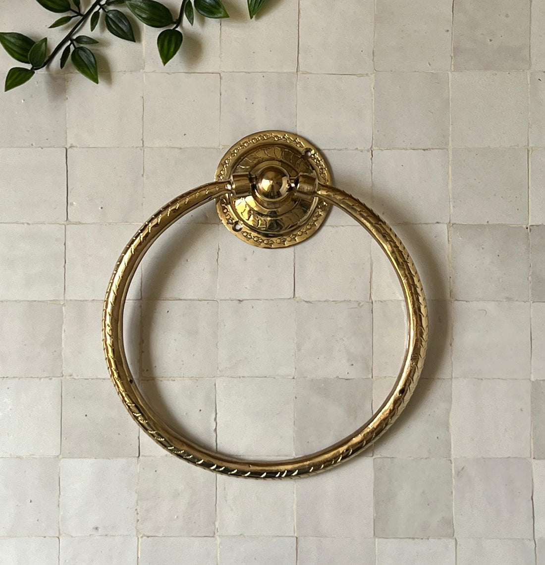 Unlacquered brass towel ring with a minimalist design for elegant bathroom decor