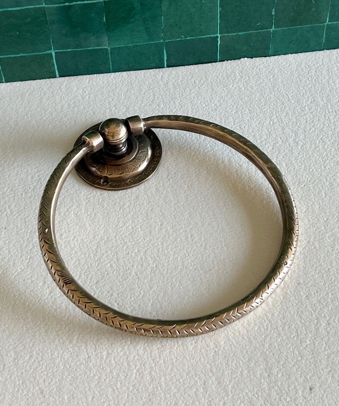 Unlacquered brass towel ring with a minimalist design for elegant bathroom decor