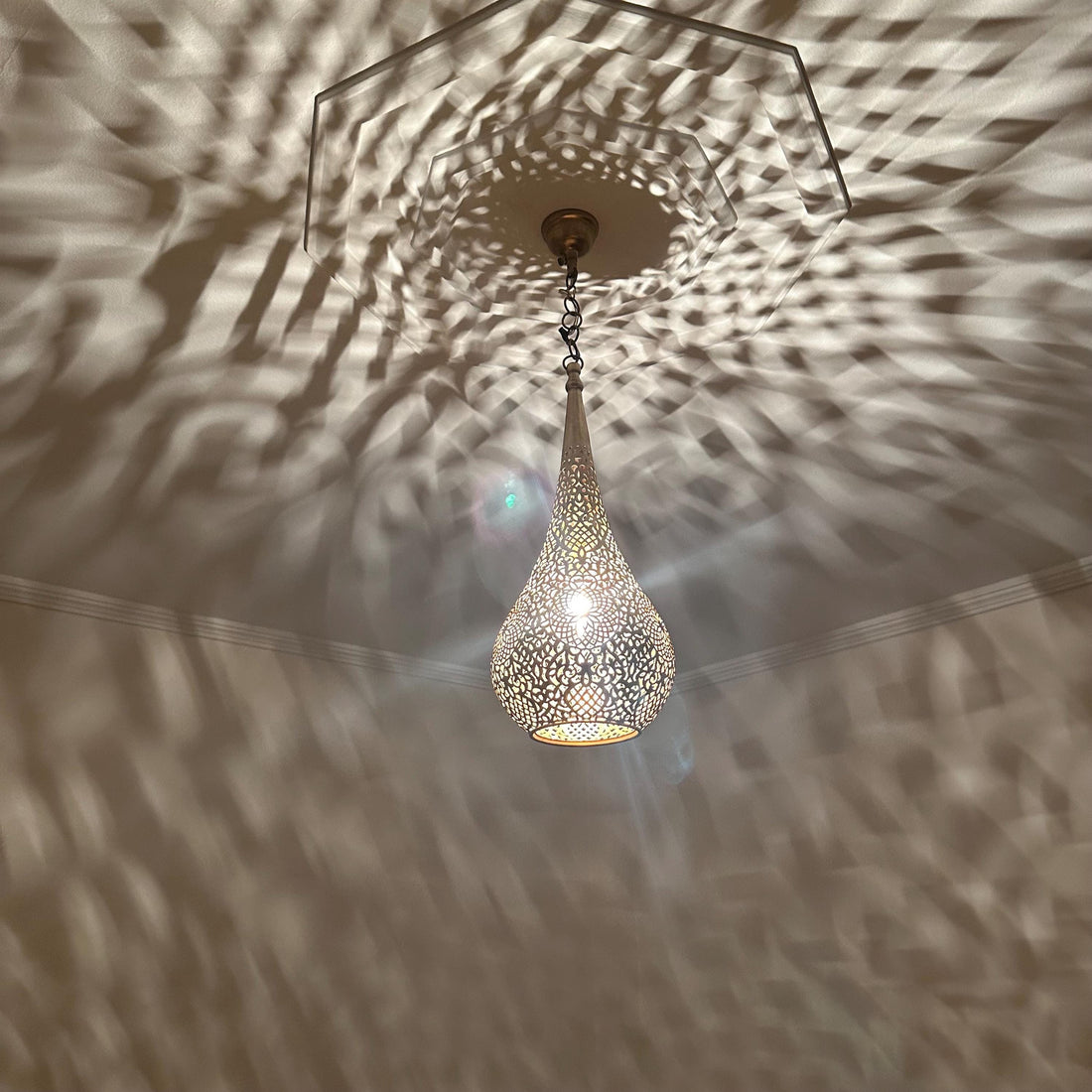 Handcrafted Moroccan brass ceiling light with intricate patterns for warm and elegant home decor