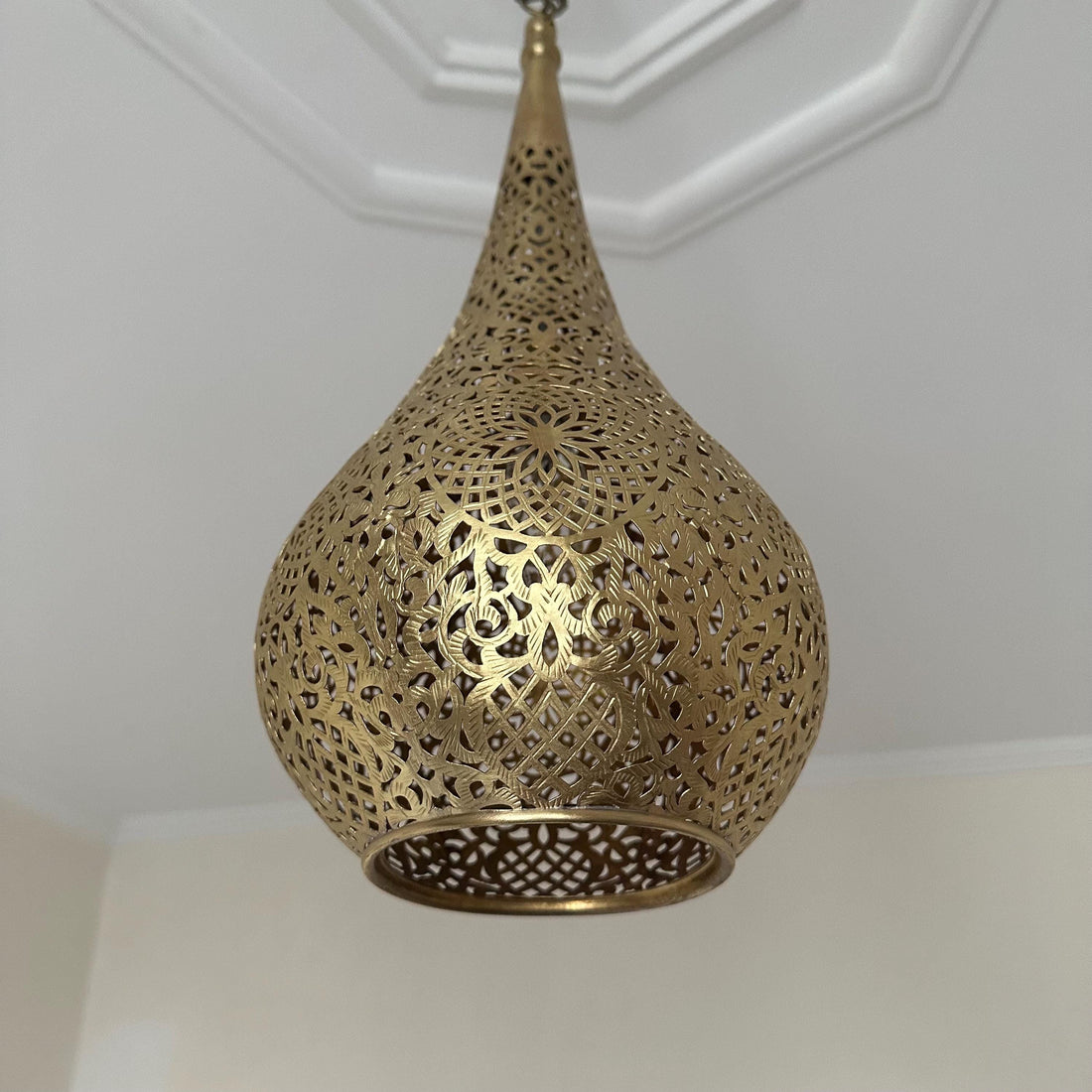 Handcrafted Moroccan brass ceiling light with intricate patterns for warm and elegant home decor