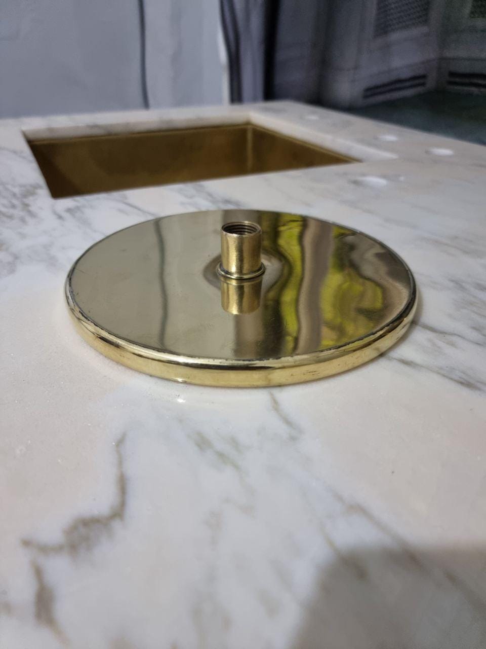 Polished brass shower head with sleek design for luxurious bathroom decor