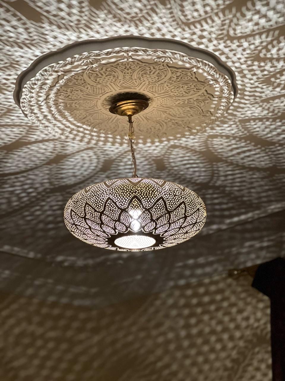 Handcrafted Moroccan pendant light with intricate patterns for warm and elegant home lighting