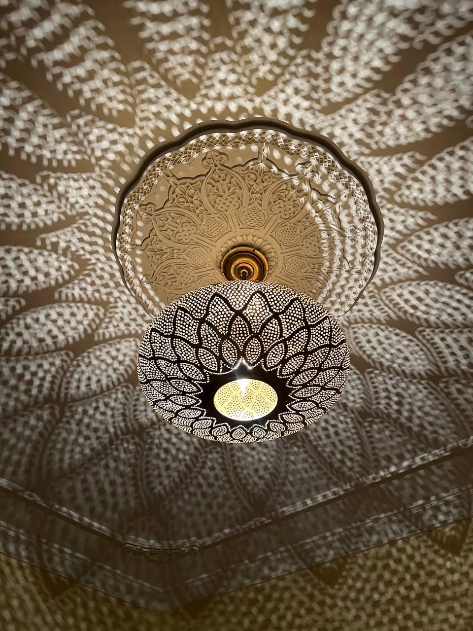 Handcrafted Moroccan pendant light with intricate patterns for warm and elegant home lighting