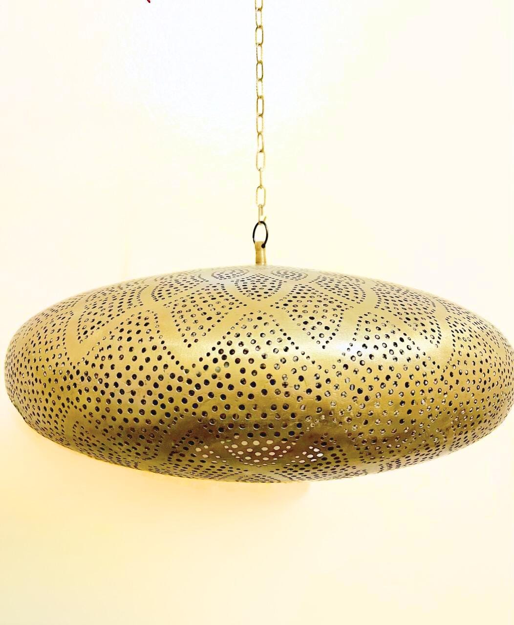 Handcrafted Moroccan pendant light with intricate patterns for warm and elegant home lighting