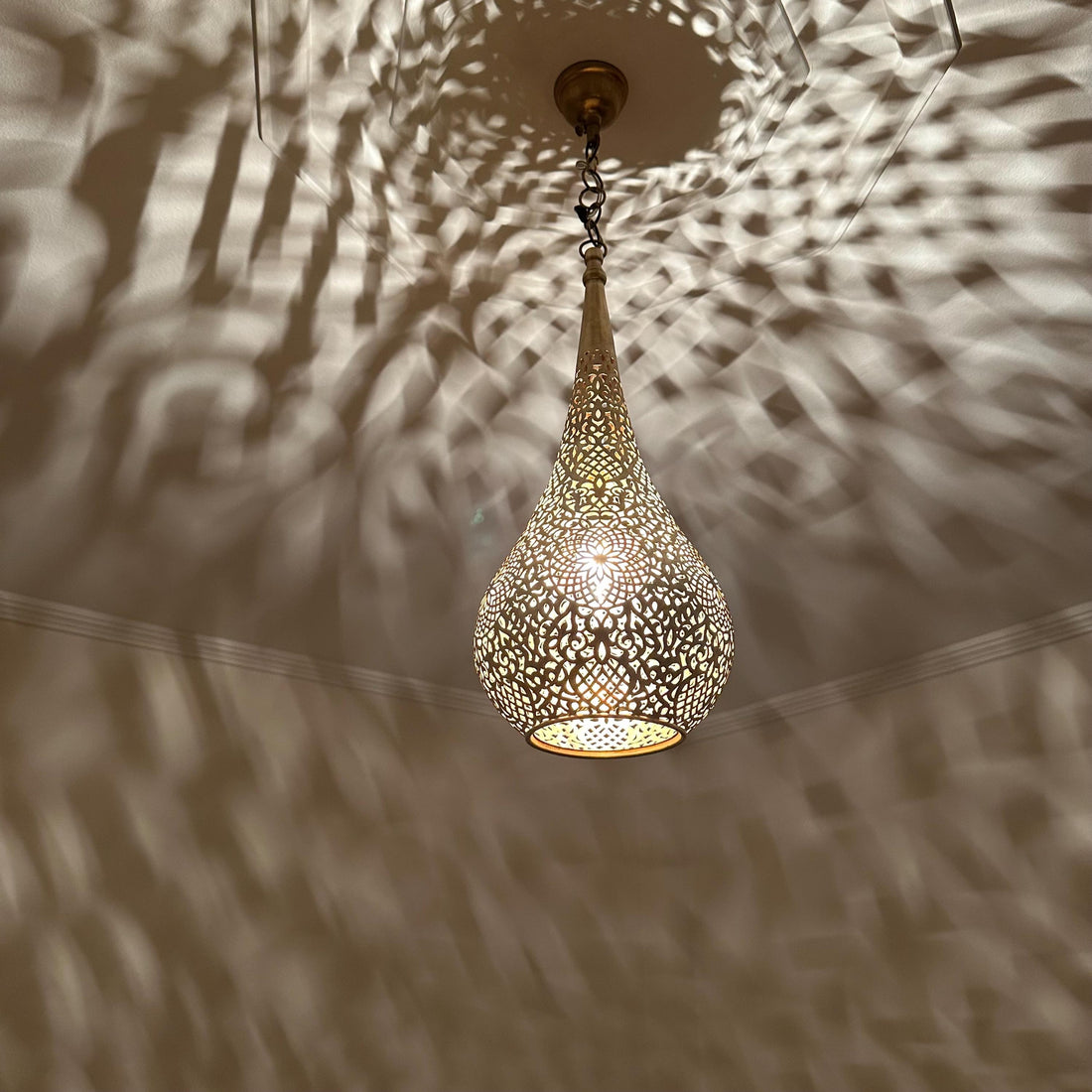 Handcrafted Moroccan brass ceiling light with intricate patterns for warm and elegant home decor
