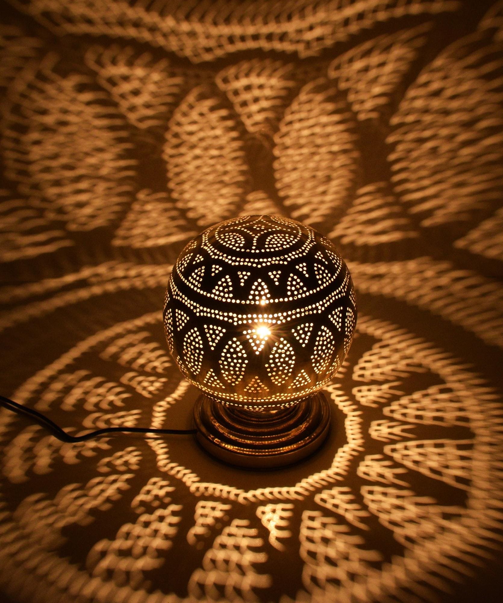 Handcrafted Moroccan brass table lamp with floral perforated cutout design

