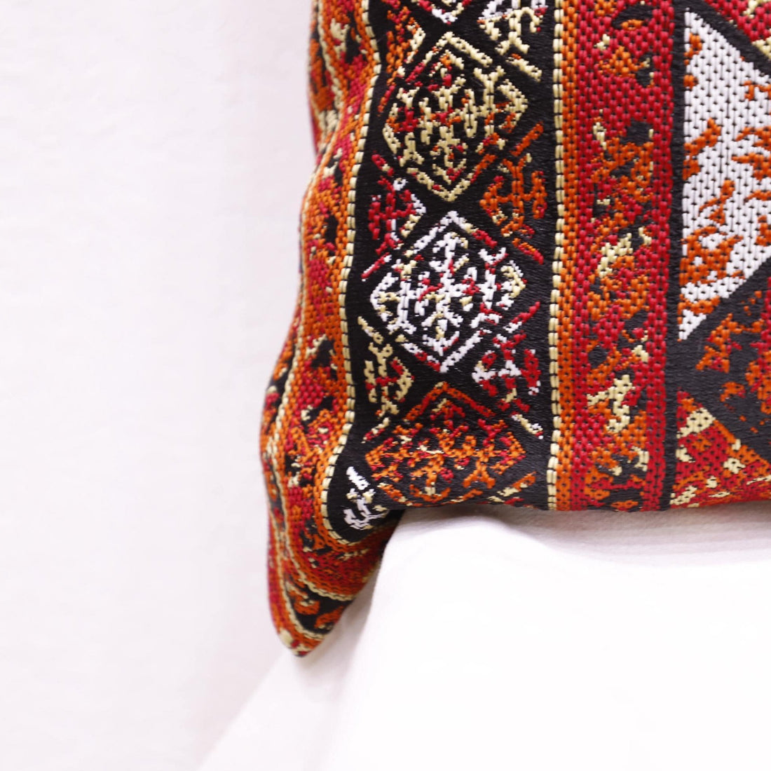 Bohemian tribal-style pillowcase displayed in a vintage-themed room.