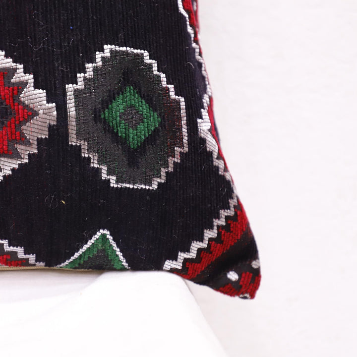 Ethnic Moroccan pillow case with traditional patterns on an accent chair.