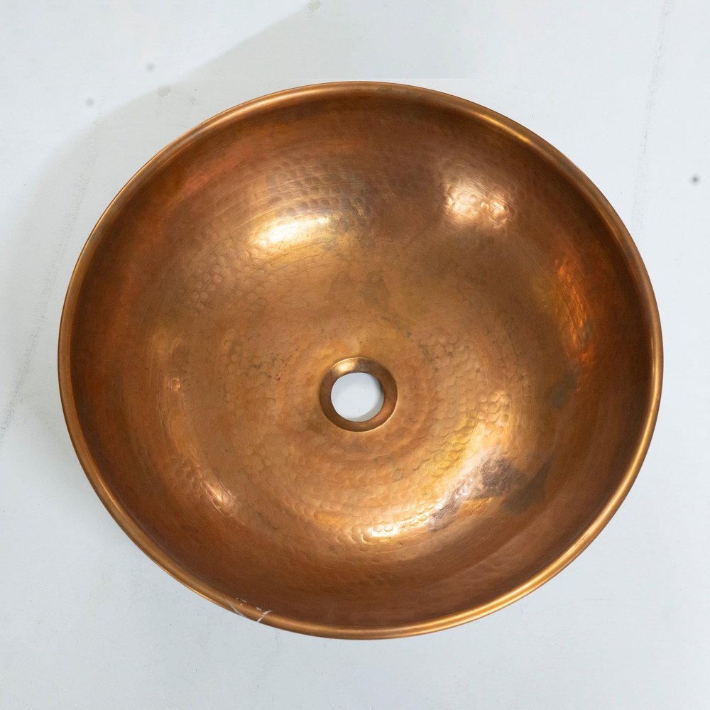 copper vessel sink basin and wood base for rustic and modern bathroom decor